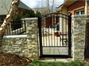 Stone wall with metal gate